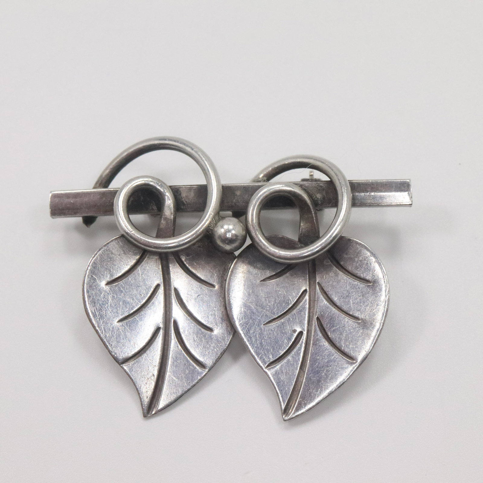 GEORGE JENSEN Sterling Silver Hand Wrought Leaf Brooch: GEORGE JENSEN Sterling Silver Hand Wrought Leaf Brooch. Marked: 109 Sterling, George Jensen Inc, Hand Wrought. Size: 1 3/4 in. x 1 1/8 in.