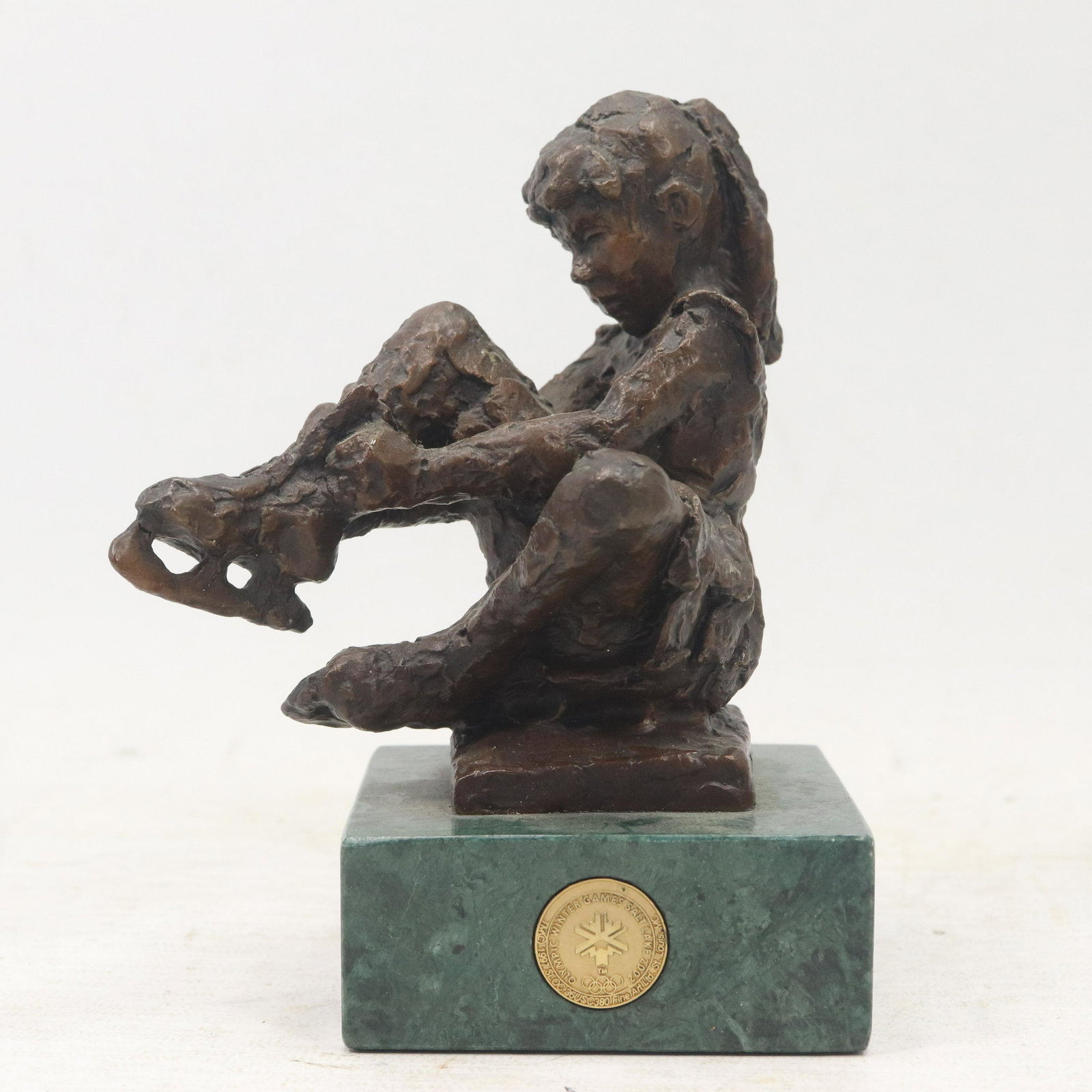 Bronze Girl Putting on Ice Skates Olympic Winter Games (1 of 6)