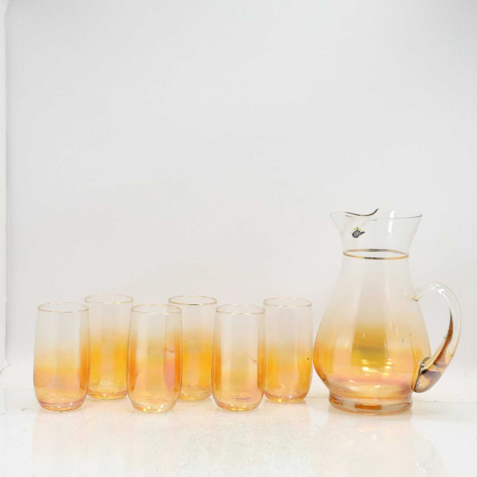 West Virginia Glass Mid-Century Orange Lemonade Set: West Virginia Glass Mid-Century Orange Lemonade Set. Pitcher with 6 Glasses. Original label. Size: (x6 glasses 5h 3w), (pitcher 10h 7w