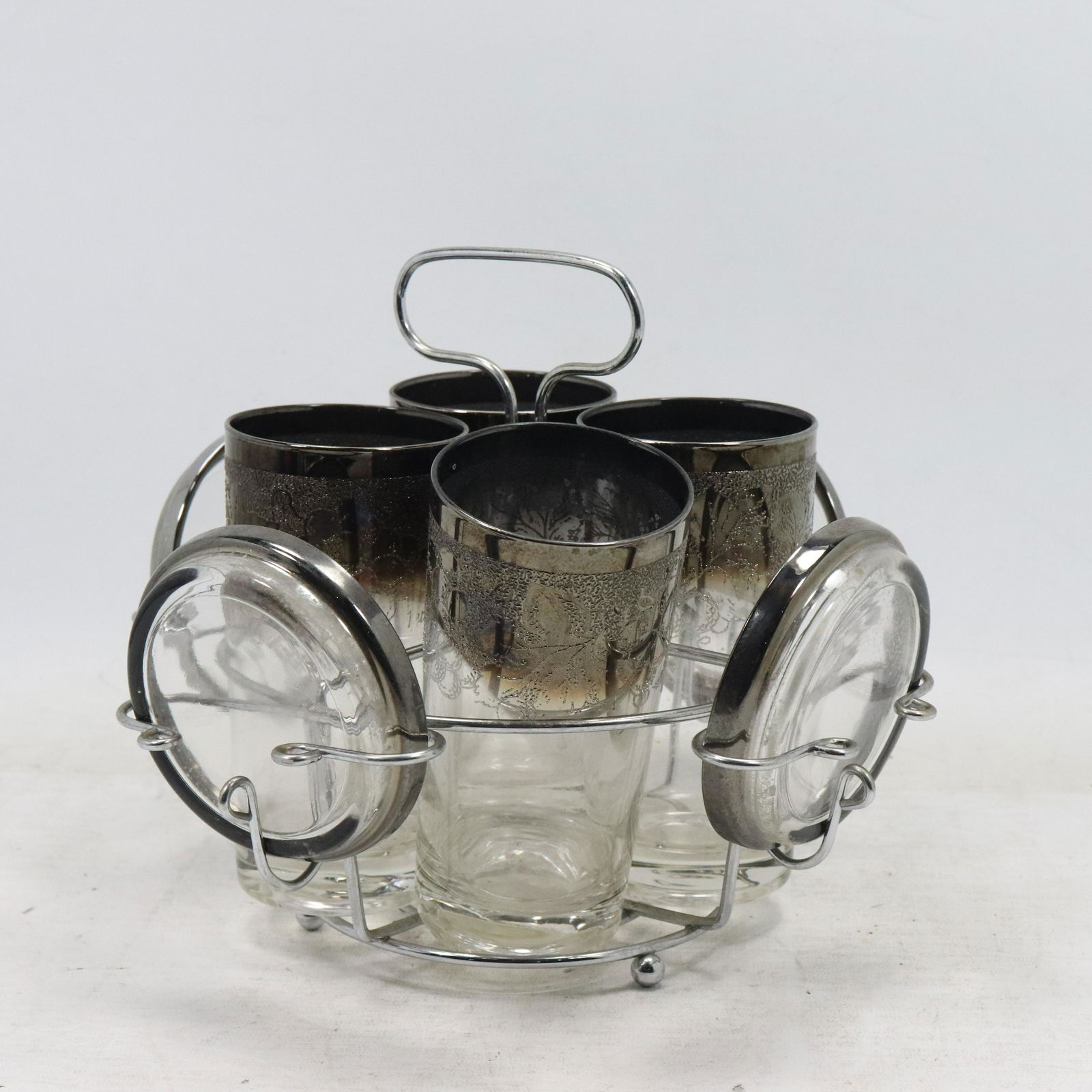 4 Silver Grapes Design Tall Glasses, Coasters in Caddy: 4 Silver Grapes Design Tall Glasses, Coasters in Caddy. Size: x4 cup 5.75h 3.75w x4 plates .75h 3.75w tray 8h 10.25w