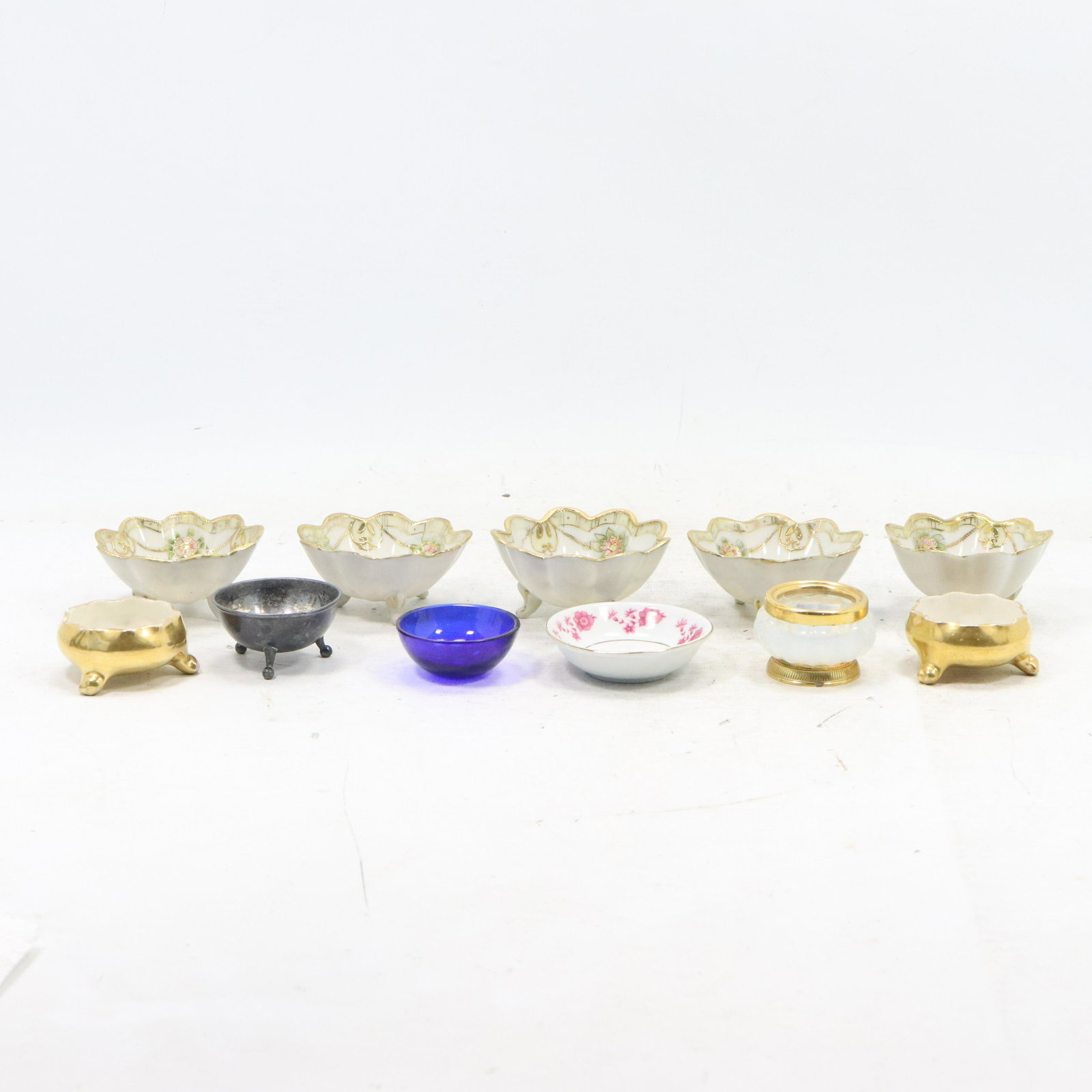 12 Assorted Master Salt Bowls in Porcelain Glass, Metal: 12 Assorted Master Salt Bowls in Porcelain Glass, Metal. Includes Nippon. Size: range .5 1.5h 2