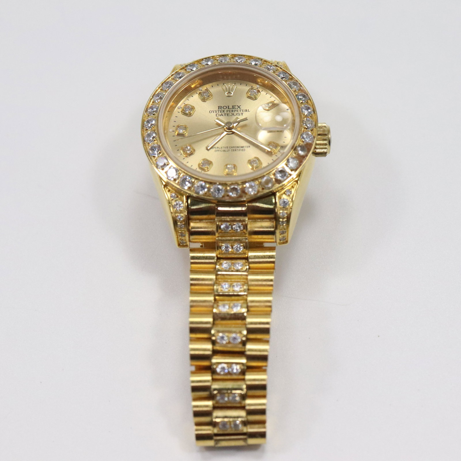 Women's Faux Rolex Wristwatch Gold Plated with CZs: Women's Faux Rolex Wristwatch Gold Plated with CZs. Working . Size: 1 1/8 in. x 1 1/2 in.