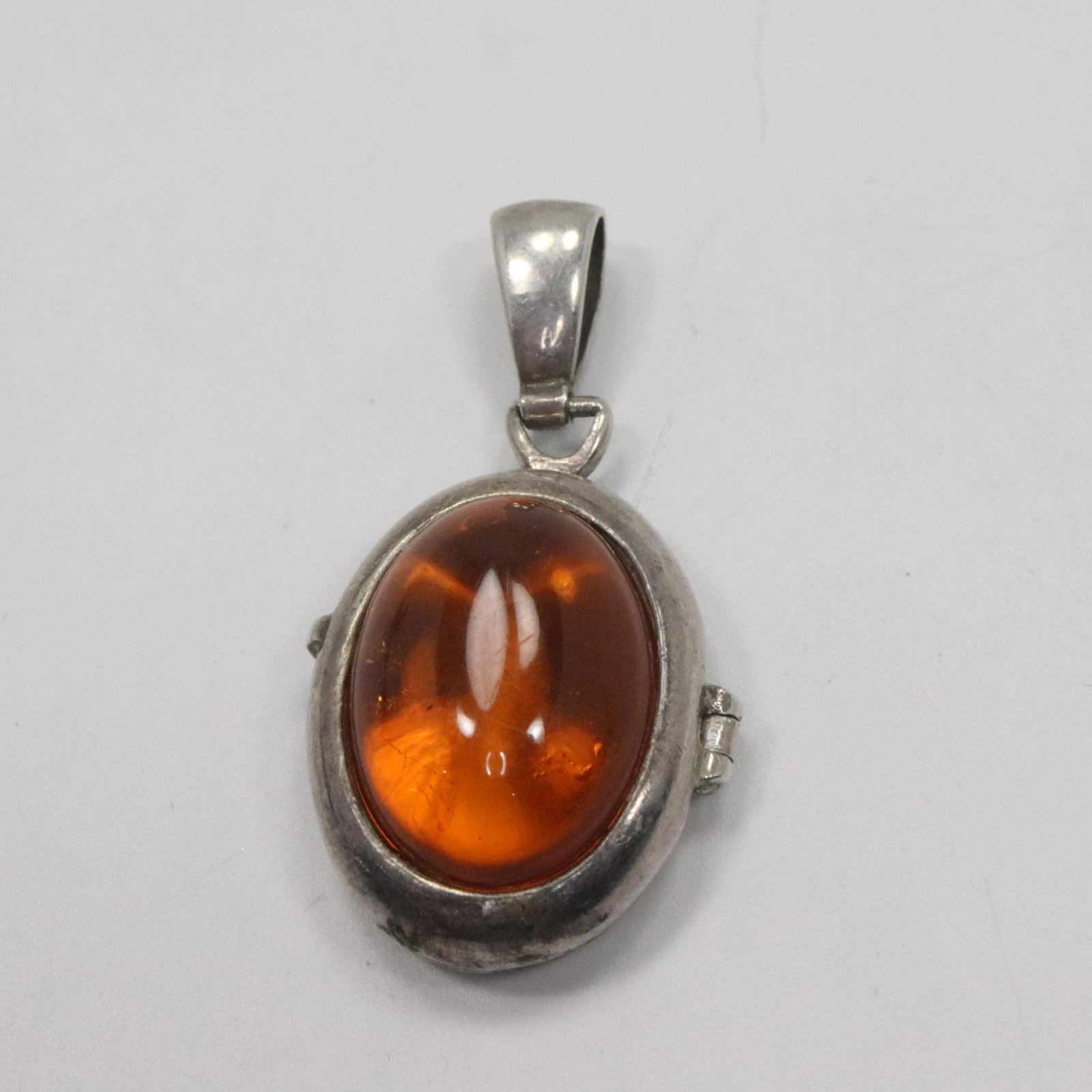 Sterling Silver Amber Locket Pendant: Sterling Silver Amber Locket Pendant. size: 1 5/8 in. x 7/8 in.