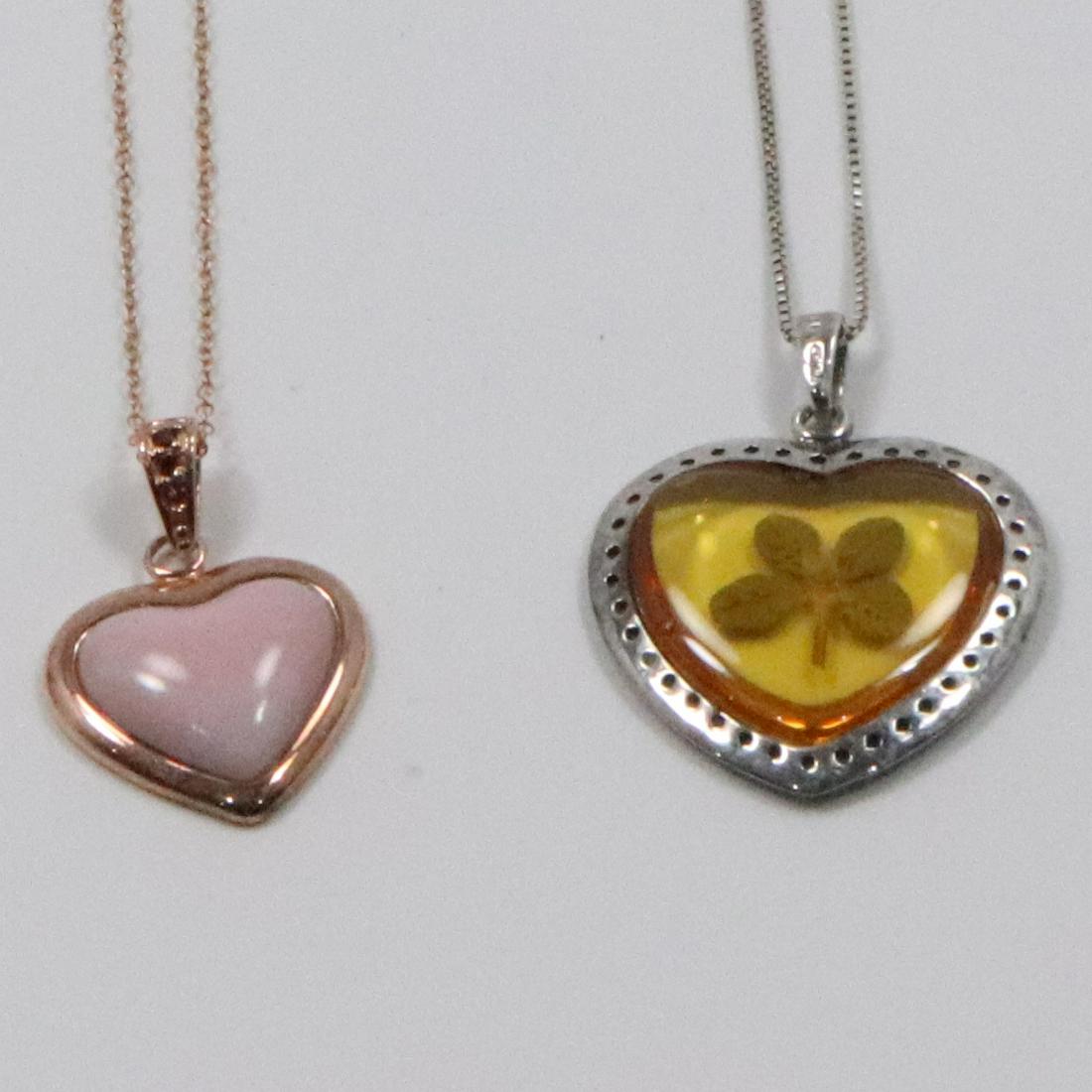 .925 Sterling Encase 4-Leaf Clover Necklace; Pink Heart: .925 Sterling Encase 4-Leaf Clover Necklace 18 in. x 1 3/8 in. x 1 1/8 in. ; Pink Heart Stones on a Bronzed Finish .925 Sterling Chain 18 in. x 1 1/8 in. x 3/4 in.
