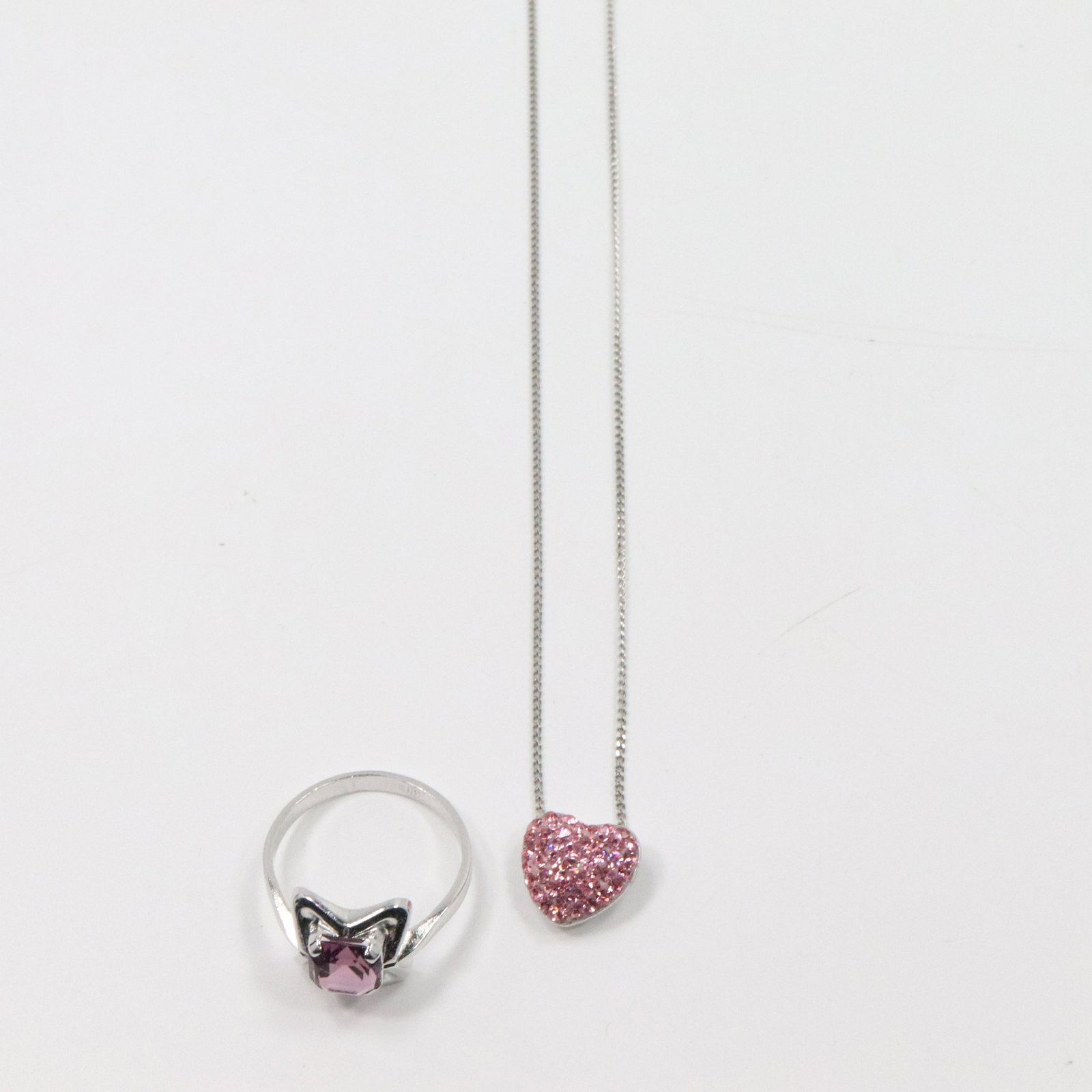 .925 Sterling Heart Pendant Necklace; Sterling Ring: .925 Sterling Heart Pendant pink stones Necklace 18 in. x 1/2 in. diameter; Sterling Amethyst Ring Size 8.25, 7/8 in. x 1/2 in.