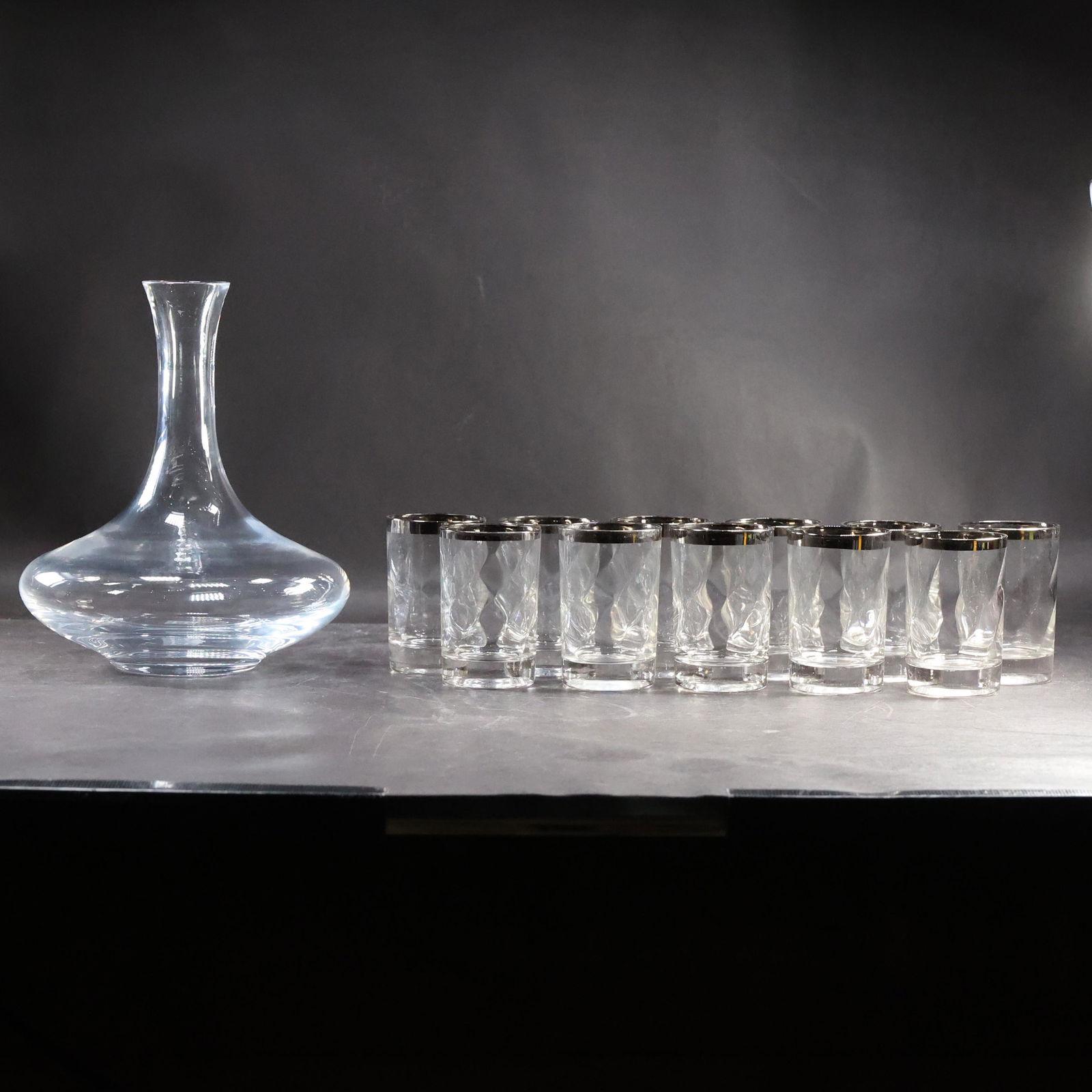 Christofle Glass Decanter and 11 Silver Rimmed Cocktail Glasses: Christofle Glass Decanter and 11 Silver Rimmed Cocktail Glasses size: 11x cups (3.5 x 2.25), pitcher (9 x 7)