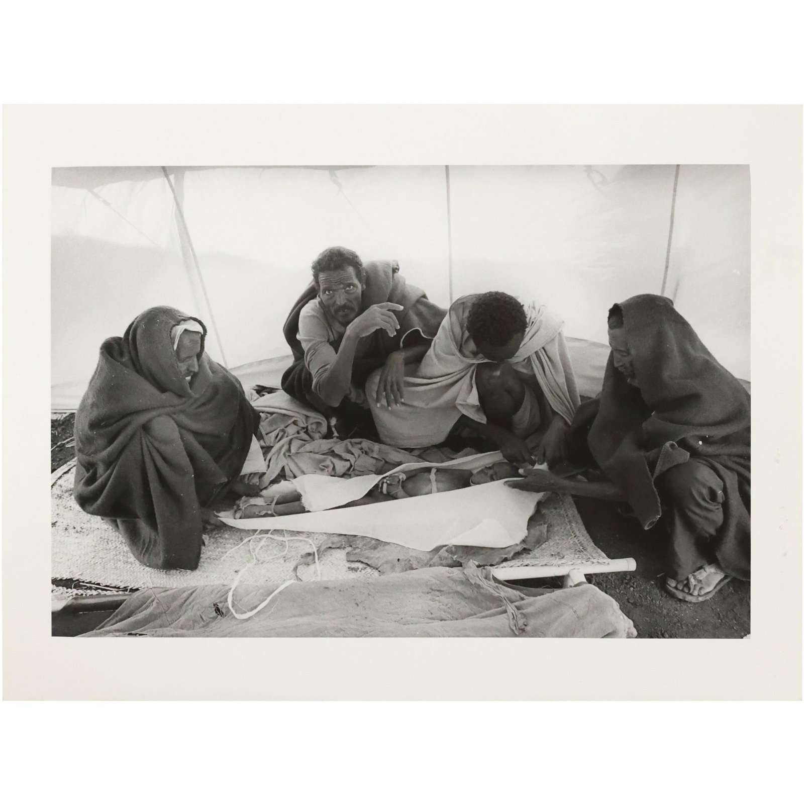 Sebastiao Salgado, Photographer; 1985 El Fau Camp Morgue Wrapping Child for Burial: Sebastiao Salgado, Photographer; 1985 El Fau Camp Morgue Wrapping Child for Burial. Information on verso. size: 7 x 9.5 Sebastiao Salgado is a Brazilian social documentary photographer and photojourna