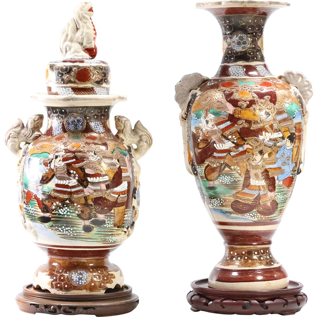 [2] Circa 1920 Japamese Satsuma Urn and Vase Decorated Samurai 16.25 inches height: [2] Circa 1920 Japamese Satsuma Urn and Vase Decorated Samurai 16.25 inches height size: (on stand 16.5 x 6), (on stand 16.25 x 6)