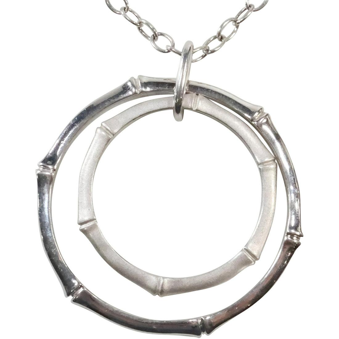 .925 Sterling Silver ELLE Double Circle Bamboo Pattern Pendant Necklace on .925 Elle Chain: .925 Sterling Silver ELLE Double Circle Bamboo Pattern Pendant 2 1/2 in. x 2 1/8 in. Necklace on .925 Elle Chain 20 in. with Ruby Tag
