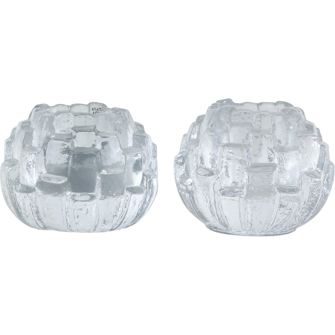 Pair KOSTA BODA "Igloo" Bengt Edenfauk Crystal Glass Votive Candle Holders with Label: Enhance the ambiance of your space with this exquisite pair of Kosta Boda 'Igloo' crystal glass votive candle holders. Designed by the renowned Bengt Edenfalk, these candle holders are a testament to