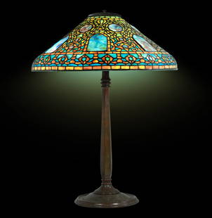 TIFFANY STUDIOS NEW YORK Signed Shade and Base  "RUSSIAN" Leaded Glass Table Lamp: The Tiffany Studios New York's signed shade and base, known as the "Russian" pattern, is a captivating embodiment of the early 20th-century artistic mastery. According to online resources the lamp dat