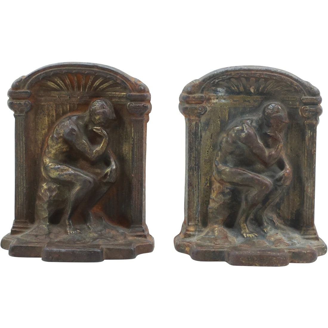 after Rodin, Circa 1920s Cast Iron Bookends "The Thinker" Seated Nude Male: pair of distinguished Art Deco bookends crafted from cast iron, dating back to the 1920s and inspired by Auguste Rodin's iconic sculpture "The Thinker." Each bookend features the classic pose of the p