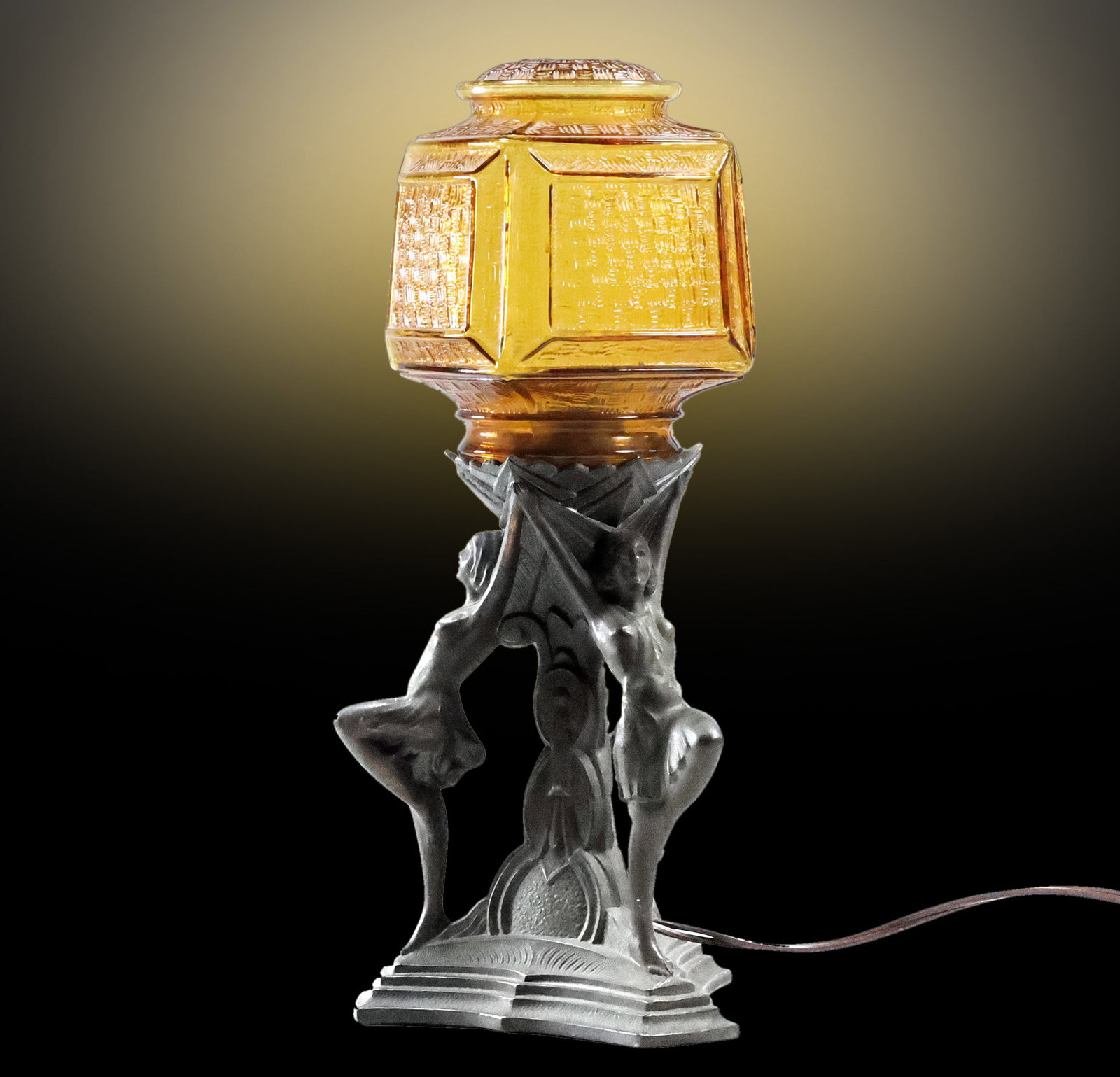 Circa 1920s Cast Metal Art Deco 3 Women Dancers Base Holding an Amber Glass Shade: Circa 1920s Cast Metal Art Deco 3 Women Dancers Base Holding an Amber Glass Shade. size: 13.5 in. x 6.5 in. x 6.5 in.