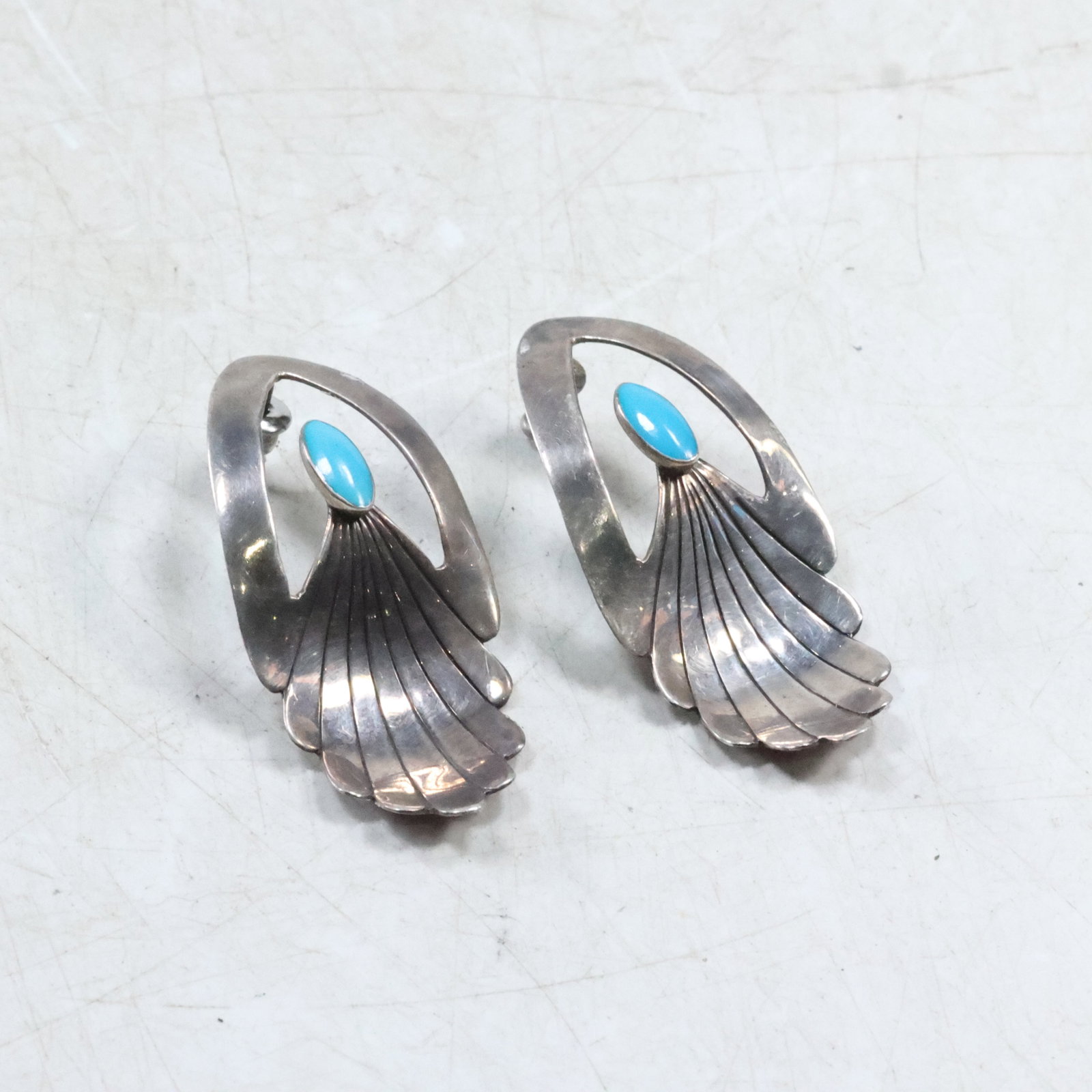 Native American Indian Clip-On Earrings Marked Sterling and Masha: size: 2"x1", Native American Indian Clip-on Earrings with a sleeping beauty turquoise stone and bent feather design. Measuring 2"x1"
