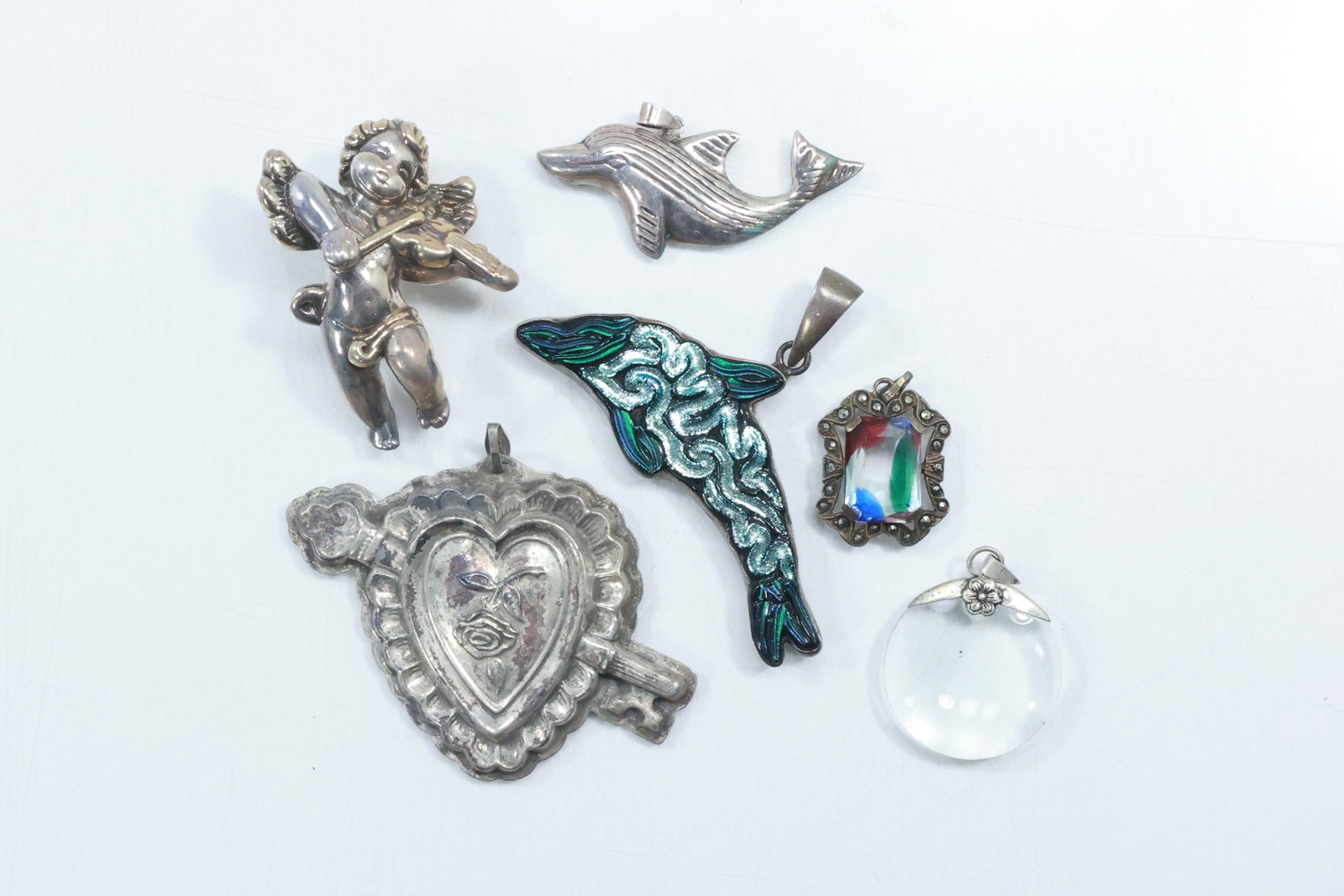 6 Assorted Sterling Silver Pins: Reed and Barton Heart; Dolphin; Cupid; Charles Alber; Glass with: 6 Assorted Sterling Silver Pins: Reed and Barton Heart; Dolphin; Cupid; Charles Alber; Glass with Marcasites; Glass Optical Pendant ; average size 2 in.
