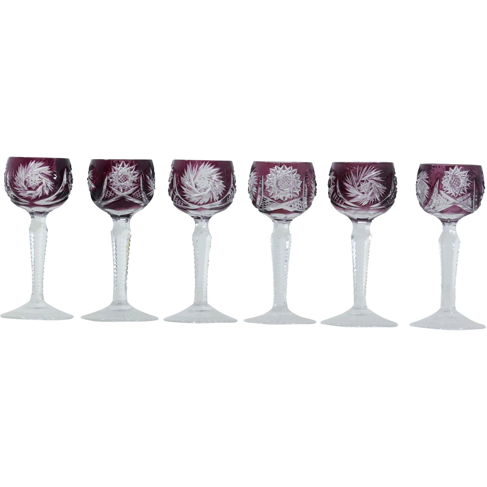 Set of Six Bohemian Cut to Clear Alexandrite Crystal Stems, 4.5 in. height: This exquisite set of six Bohemian crystal smaller wine stems showcases the timeless elegance of cut-to-clear glass craftsmanship. Each stem features a deep grape-colored Alexandrite glass bowl, intri
