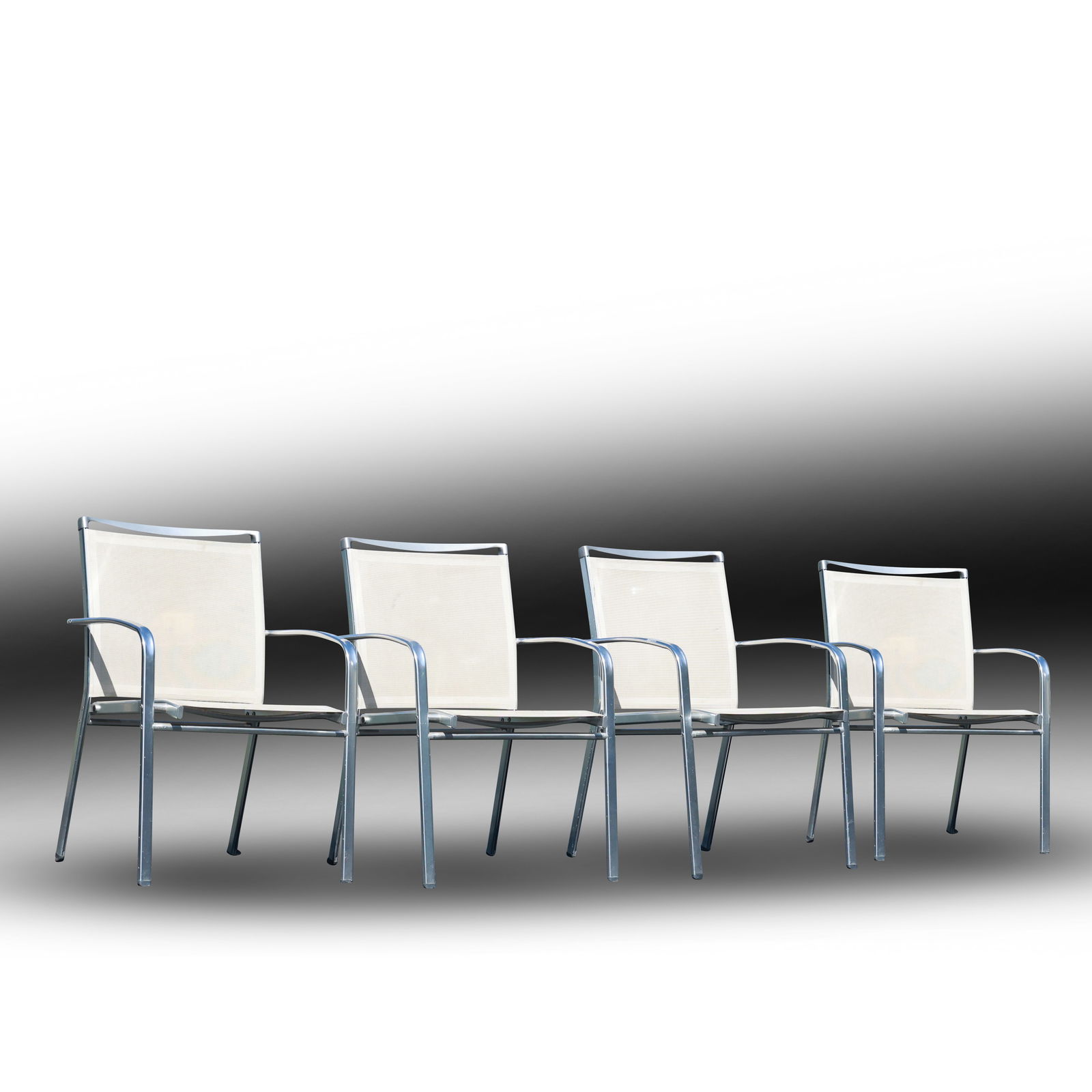 Set of 4 Aluminum Chairs with Mesh Seats - Kurt Thut Knoll Herman Miller Style: This set of four aluminum chairs with mesh seats is styled in the design traditions of Kurt Thut, Knoll, and Herman Miller. Marked on the back with an unidentified maker, these chairs combine sleek, m