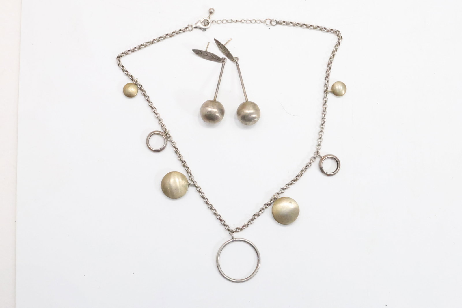 .925 Sterling Silver Hoops and Discs Necklace 18 in. x 1 in. & unsigned Sterling Leaf Stud with Ball: .925 Sterling Silver Hoops and Discs Necklace 18 in. x 1 in. & unsigned Sterling Leaf Stud with Ball Drop 2 1/2 in. x 1/2 in. weighs 33.2 grams total