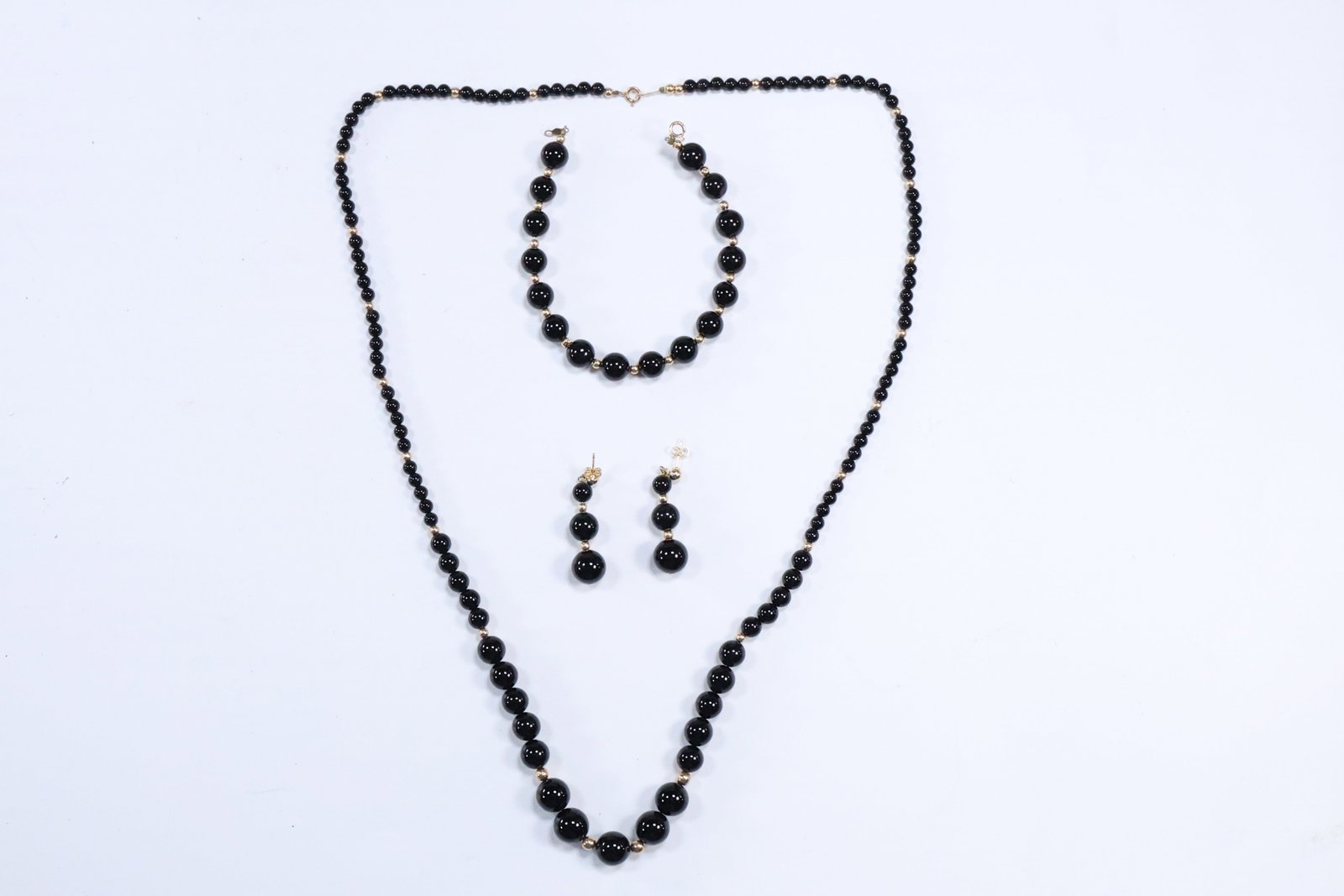 4 Piece 14K Gold Beads and Clasp with Black Onyx Beads: Necklace 25 in. x 3/8 in., Bracelet: 4 Piece 14K Gold Beads and Clasp with Black Onyx Beads: Necklace 25 in. x 3/8 in., Bracelet 7 in. x 1/4 in.; Earrings 1 1/2 in. x 3/8 in.