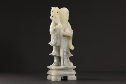 Chinese soapstone carving of Shoulao, the God of Longevity, holding a staff and a peach, which are s