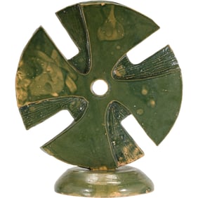 Signed "N E ", Art Pottery Green Glazed Sculpture Cross shape with a central hole, mounted on a base