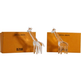 2 Oleg Cassini Crystal Glass Giraffe Figurines, each presented with its packaging box.