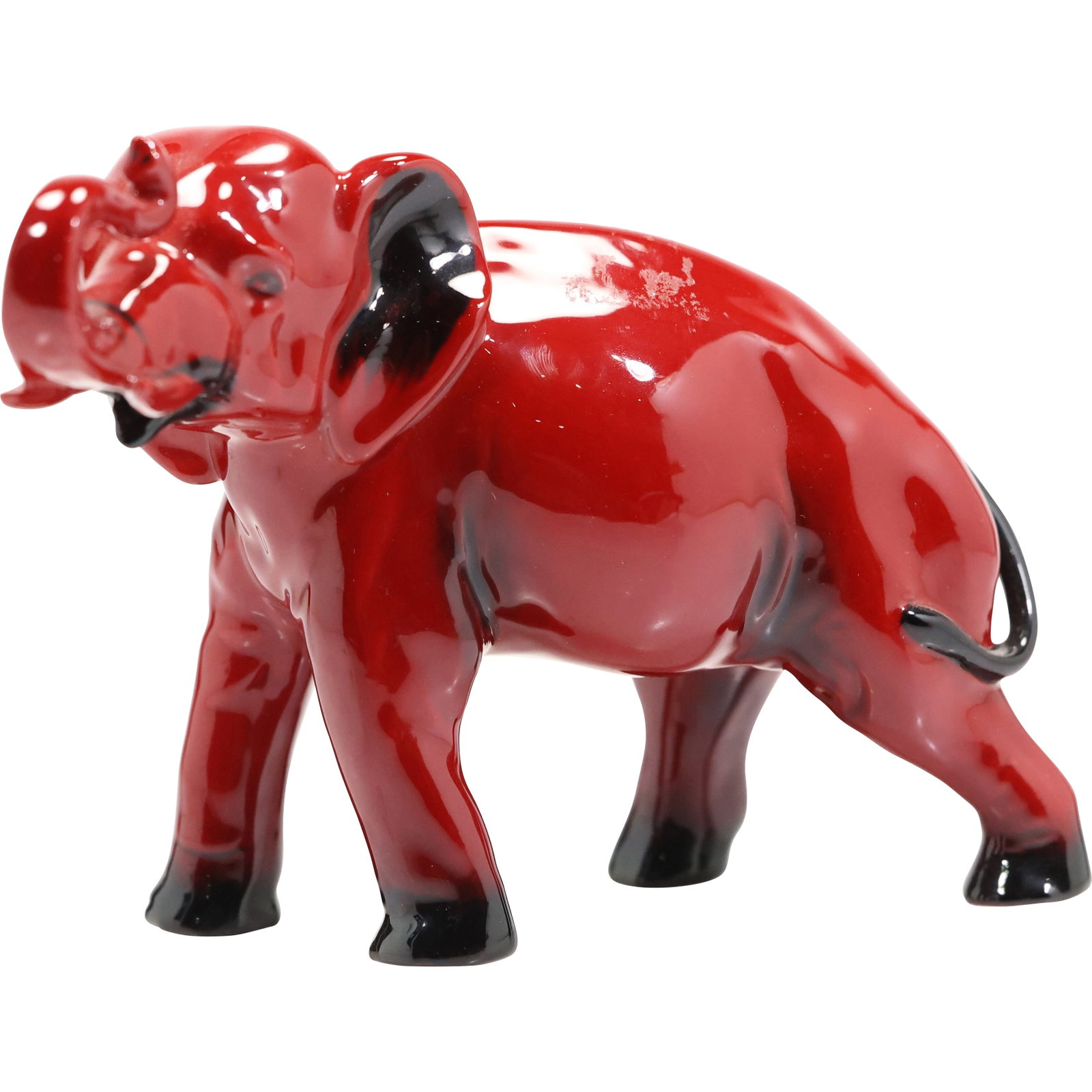 Royal Doulton Flambe Elephant Figure, Red, Designed by Charles Noke, 5.5 in. height x 8 in. wide: Royal Doulton Flambe Elephant figurine. This particular model, with the trunk raised in salute, is known as HN891A or HN891B (depending on size). It was designed by Charles Noke and issued between 192