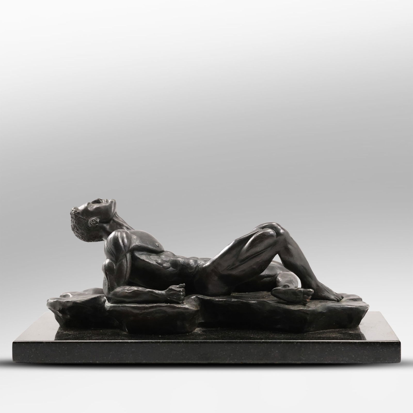 Quality Bronze Sculpture of a Reclining Nude Male Mounted on a Black Marble Base, Original Patina: Quality Bronze Sculpture of a Reclining Nude Male Mounted on a Black Marble Base, Original Patina. size: 7 inch height, 14 inches length S:A