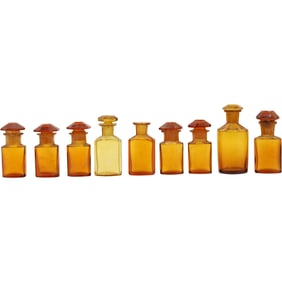 Grouping of 8 vintage amber glass apothecary jars with stoppers,. plus 1 no stopper