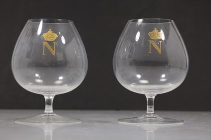 pair of Baccarat crystal cognac or brandy snifters featuring a gilded "N" with a crown and laurel wr