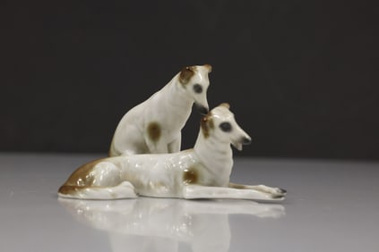 pair of Borzoi dog figurines, likely made of porcelain or ceramic.