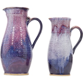 two Signed Studio Pottery handmade ceramic pitchers with a blue and purple crystalline glaze.