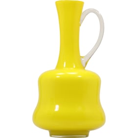 vintage mid-century modern Empoli hand-blown cased glass pitcher in yellow with a clear handle.