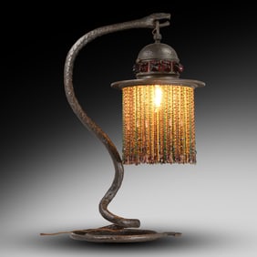 Fabulous Art Nouveau bronze snake-form table lamp with an amber glass beaded shade. 26 in. height