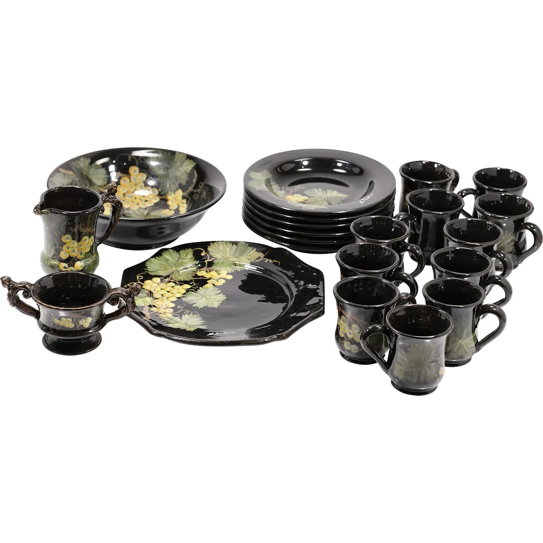 Black Ceramic dinnerware decorated with a grape and leaf motif , Artist Signed, See Pictures: " This item requires an appointment scheduled via email (donny@donnymaloneauctions.com) at least 24 hours before pick-up. Black Ceramic dinnerware decorated with a grape and leaf motif , Artist Signed