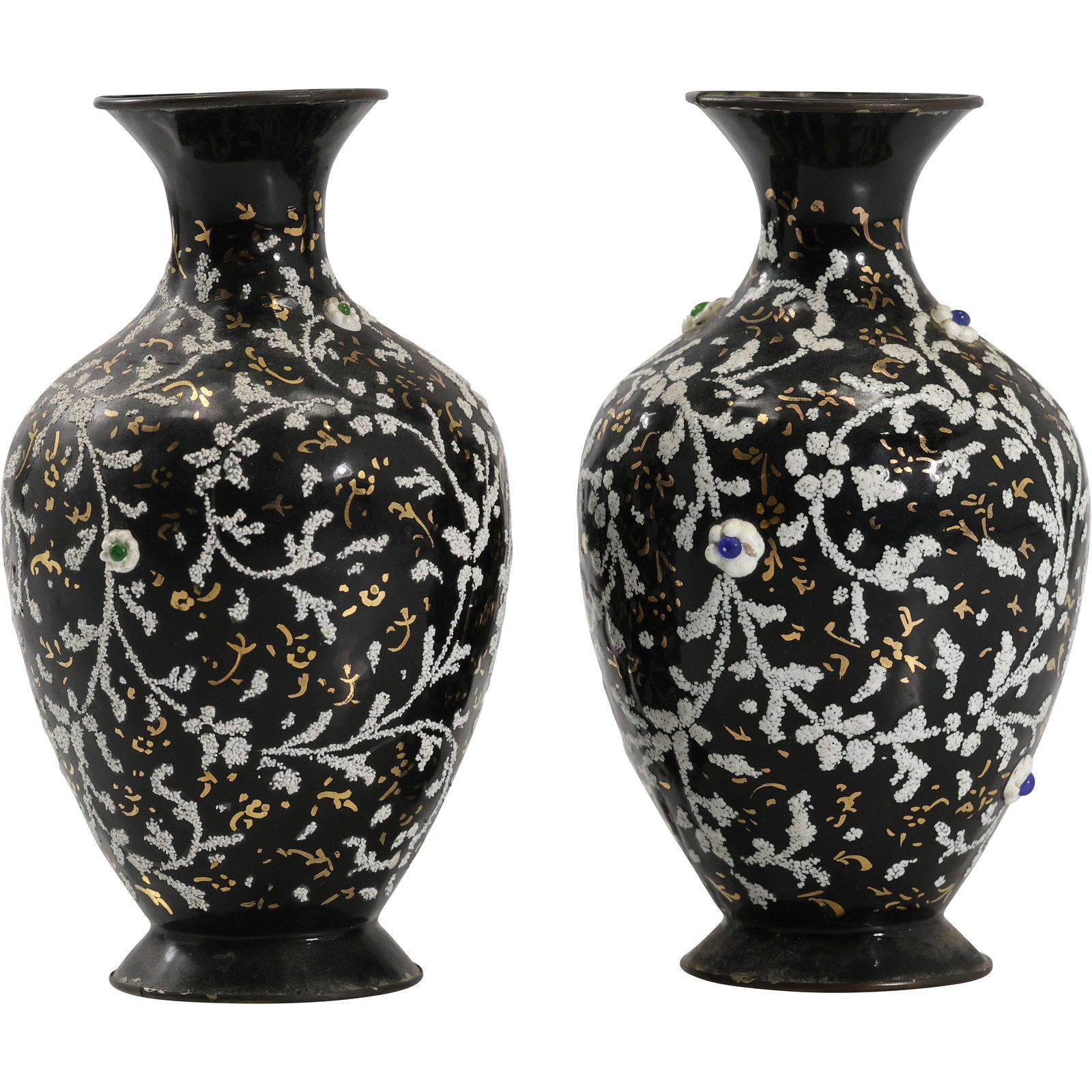 Pair of Persian Enamel on Metal Vases with Gilt and Floral Embellishment: Pair of enamel-decorated metal vases made in Iran, each featuring a flared neck and rounded body with a black ground densely patterned in gilt scrollwork and raised white floral branches. Small enamel