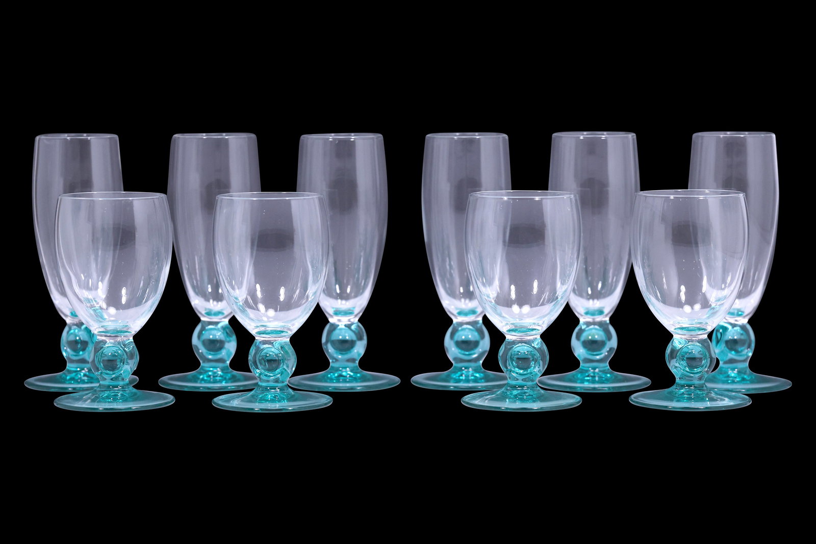 Set of Ten Vintage Aqua Green Stemmed Glasses Attributed to Luminarc: Set of ten vintage glass goblets including six larger flutes and four smaller stemmed glasses, each with clear bowls over aqua green bases. Attributed to Luminarc or Moliere-style French production, o
