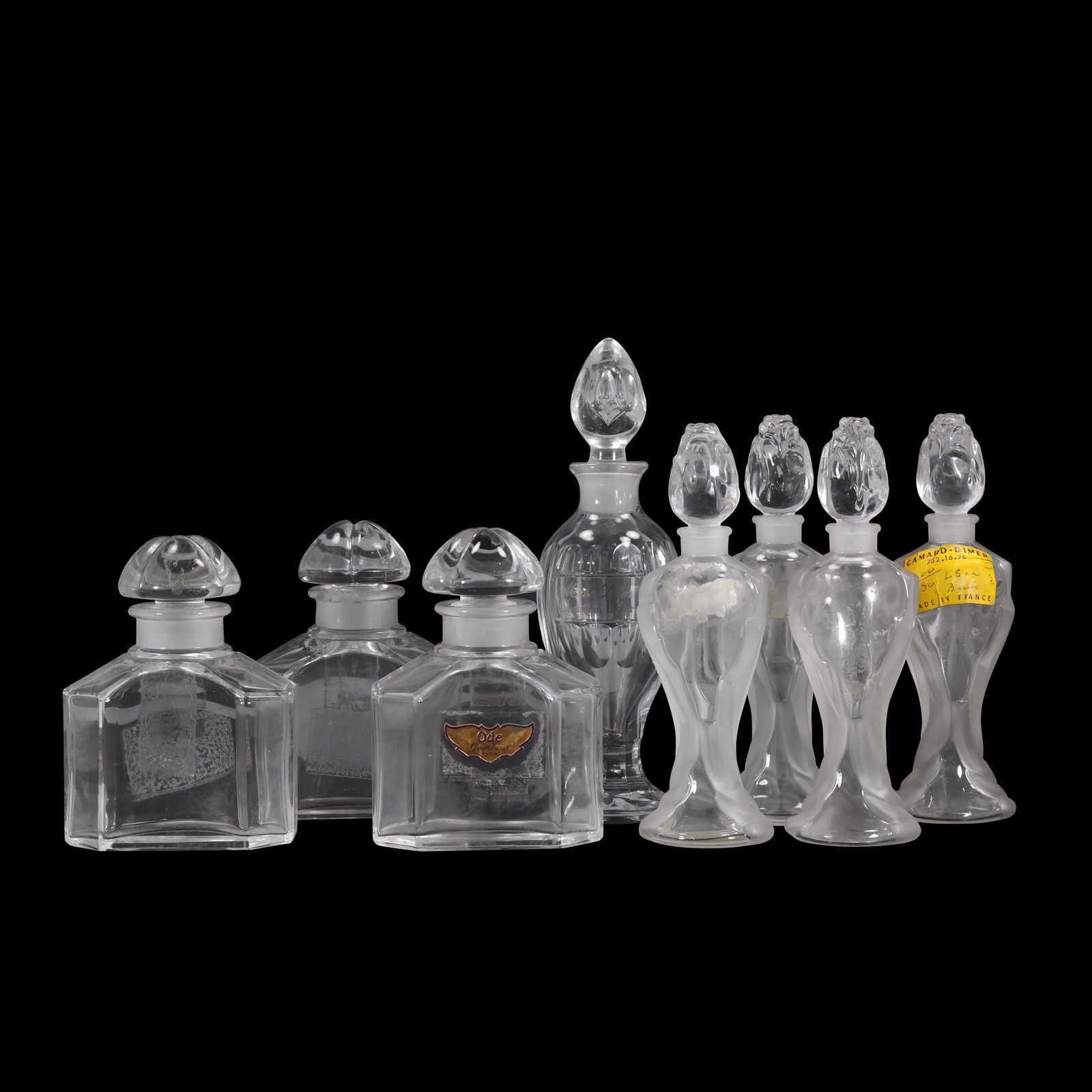 Baccarat French Perfume Bottles Guerlain Miss Dior and Art Deco Vanity Bottles: Group of clear glass perfume bottles including three matching octagonal Guerlain Paris bottles with ground stoppers and molded bases marked Guerlain Paris France with the circular Baccarat France mark