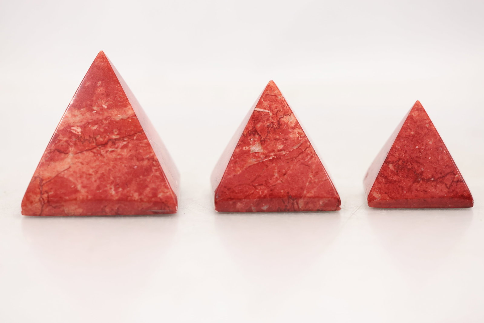 Group of Three Red Stone Pyramid Form Decorative Paperweights (1 of 8)