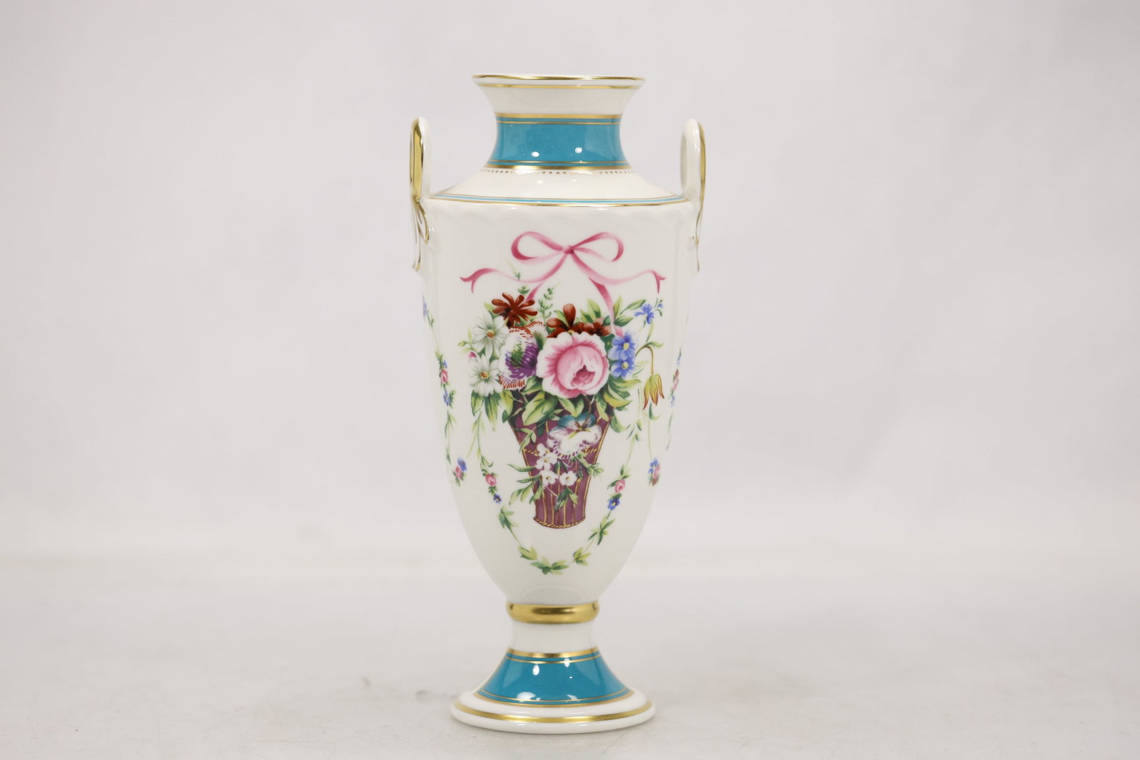Minton Rose Basket Pattern No. 5007 Porcelain Cabinet Vase: Fine English porcelain cabinet vase by Minton, decorated in the desirable Rose Basket pattern No. 5007. The elegant urn-form vase features richly detailed hand-painted floral bouquets, delicate ribbon