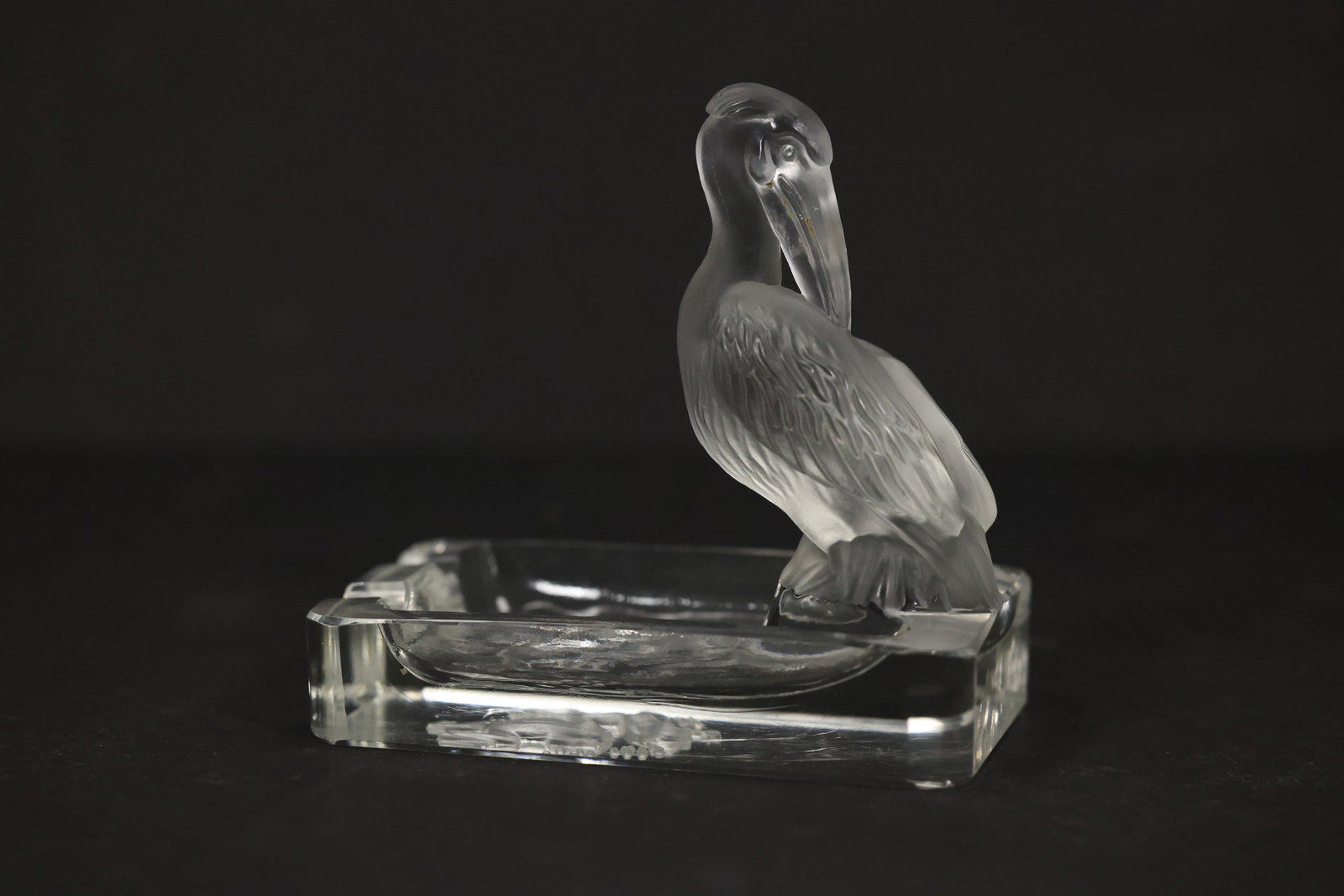 Lalique Style Frosted Crystal Pelican Ashtray: Decorative clear and frosted crystal ashtray featuring a sculpted pelican perched along the rim. The bird is finely detailed with textured feathers, a curved beak, and a satin-frosted finish that cont