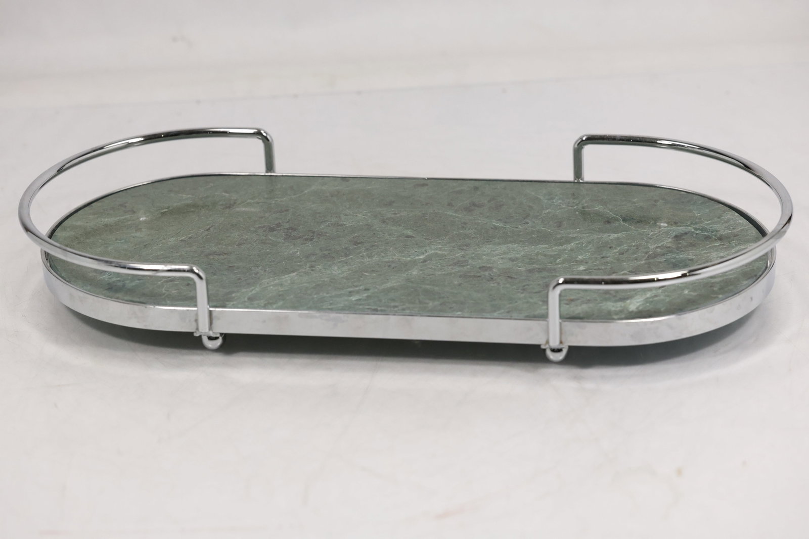 MCM Green Marble Stone Vanity Tray with Chrome Metal Gallery Handles: Green stone vanity tray featuring an elongated oval form with rounded ends and a polished chrome tone metal frame. The tray has a mottled green surface with natural veining and mineral variation consi