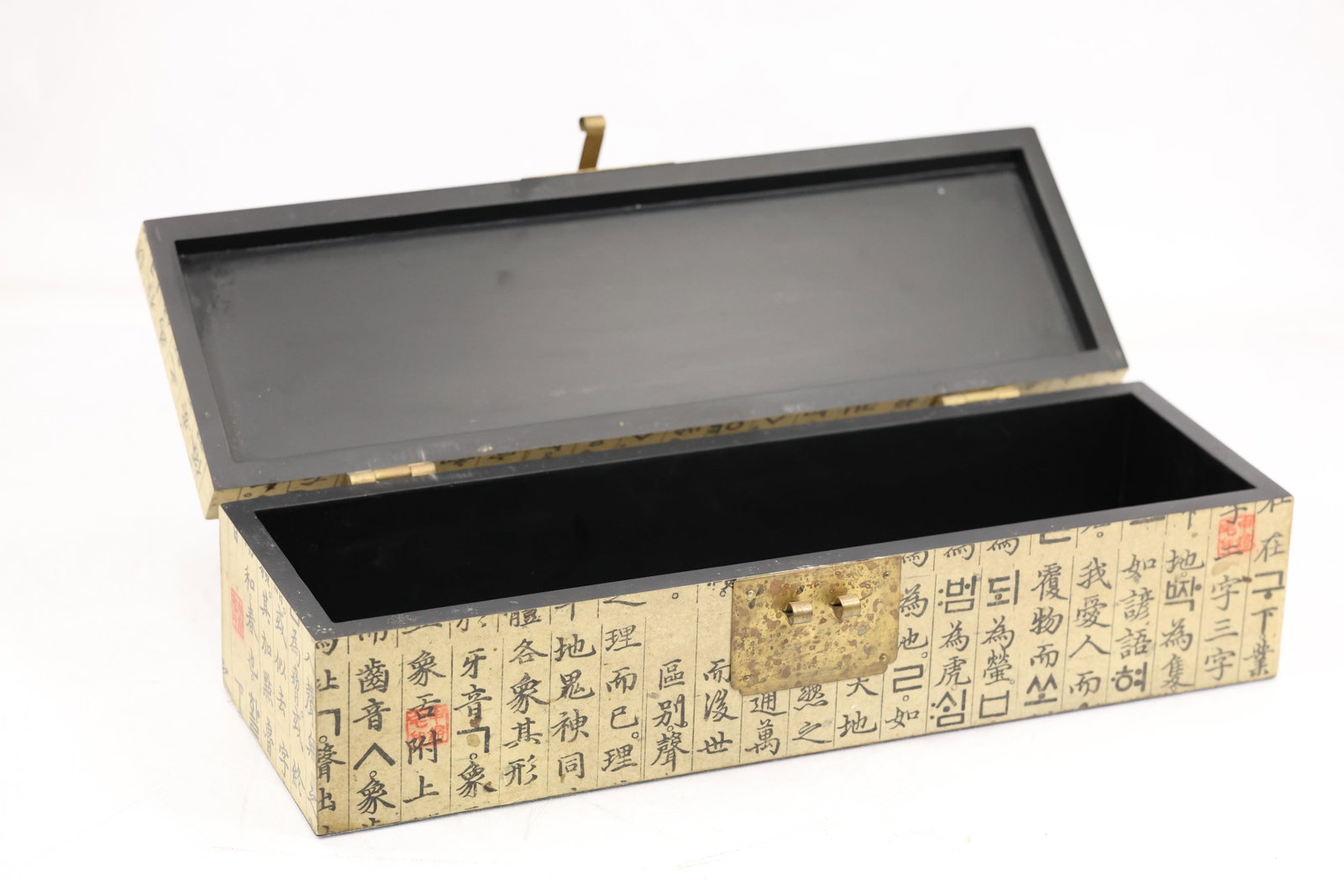 Asian Calligraphy Covered Hinged Decorative Box: Rectangular hinged decorative box covered with repeated Asian calligraphy script over a light ground. The interior is finished in black and the box has a long low profile. The text based surface