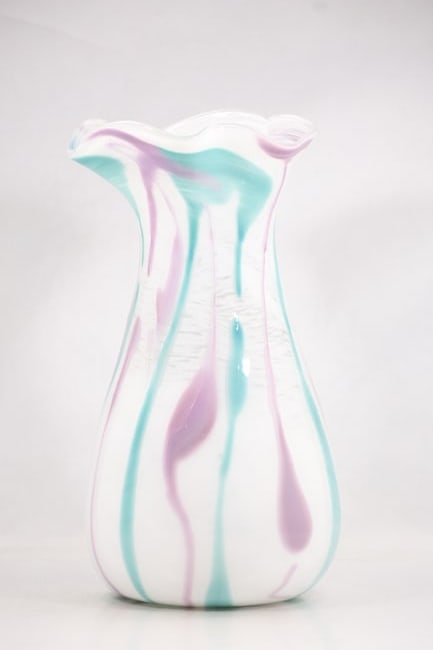 Tall White Aqua and Lavender Striped Art Glass Vase: Tall clear art glass vase with white aqua and lavender pulled stripes rising through the body to a wavy rim. The broad vessel has a hand formed organic silhouette. The vertical color trails relate to