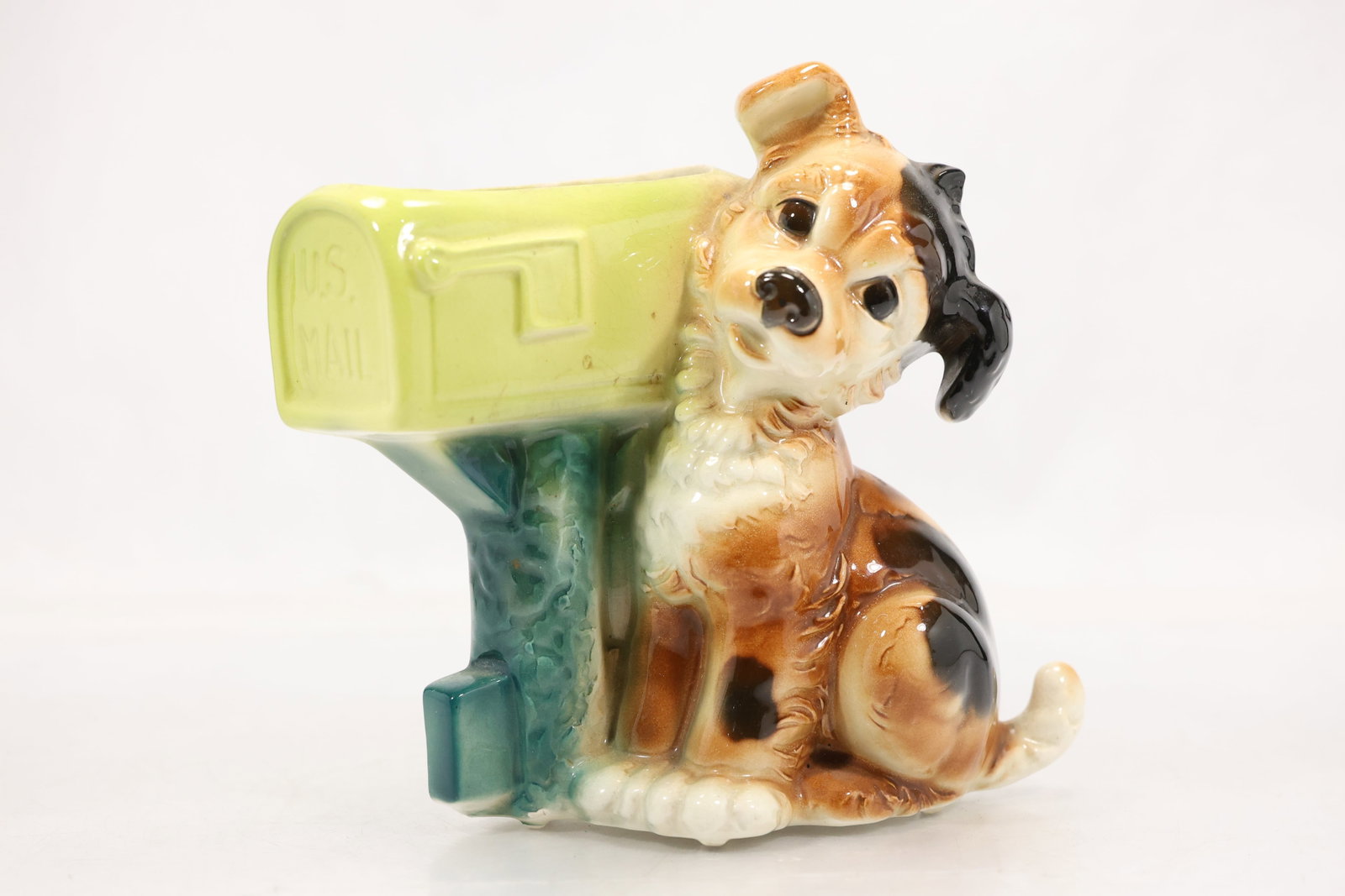 Vintage Glazed Ceramic Dog and Mailbox Planter: Glazed ceramic novelty planter modeled as a seated brown white and black dog beside a green mailbox form container. Raised lettering appears on the mailbox side and the open top provides space for a s