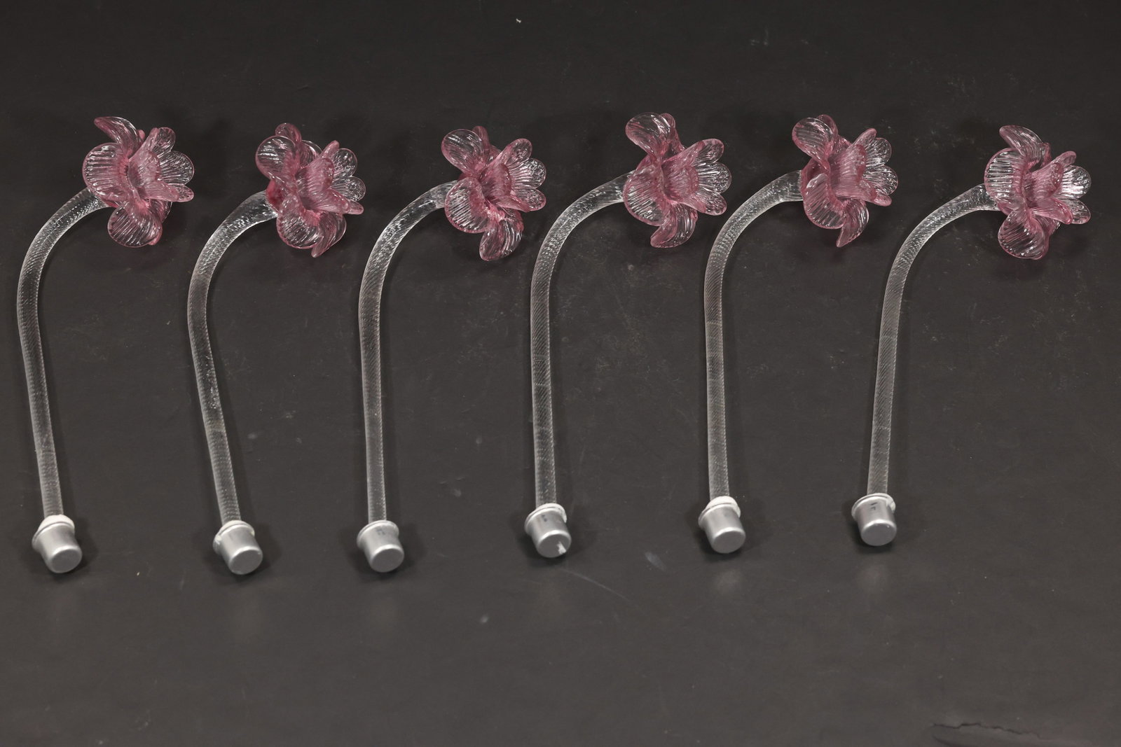 Set of Six Pink Murano Glass Flower Chandelier Stems: Set of six vintage mid century Murano glass pink flower chandelier stems from confirmed importer stock. Each clear curved stem terminates in a small layered pink blossom creating a delicate botanical 