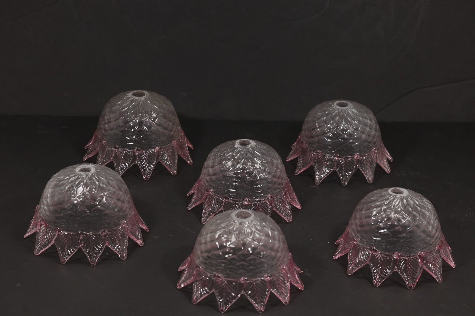 Set of Six Pink Tip Murano Glass Bell Chandelier Shades: Set of six vintage mid century Murano glass clear and pink bell chandelier shades from confirmed importer stock. Each ribbed bell form has a central mounting aperture and a flared petal rim accented b