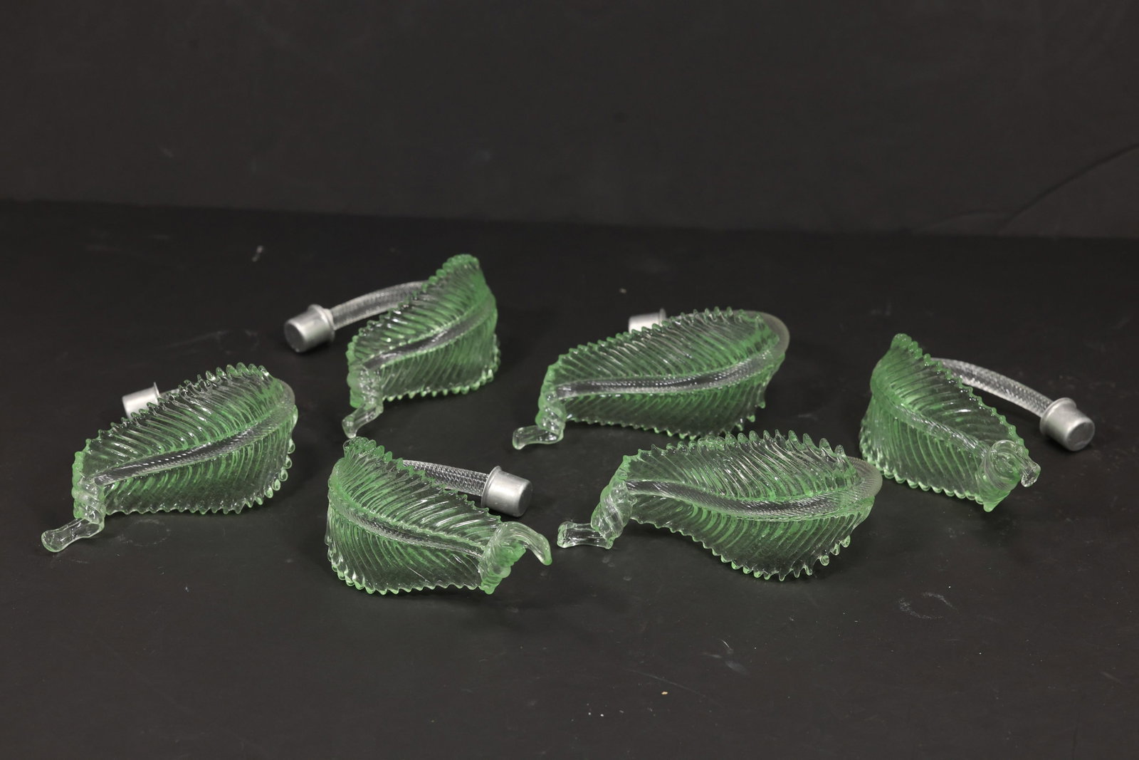 Set of Six Green Murano Glass Leaf Chandelier Parts: Set of six vintage mid century Murano glass green foliage chandelier replacement parts from confirmed importer stock. Each compact element has a curved stem strongly ribbed leaf body serrated edge and