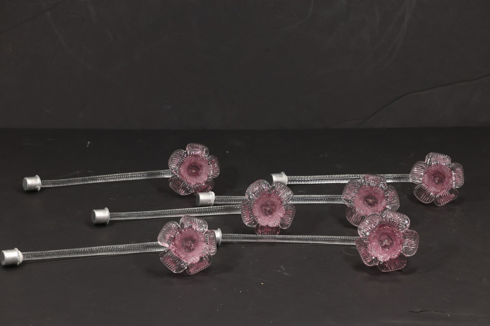 Set of Six Pink Murano Glass Flower Chandelier Stems: Set of six vintage mid century Murano glass pink flower chandelier stems from confirmed importer stock. Each long clear support terminates in a layered rose blossom with a darker center and radiating 