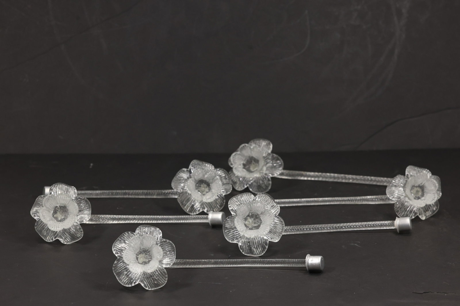 Set of Six Clear Murano Glass Flower Chandelier Stems: Set of six vintage mid century Murano glass clear flower chandelier stems from confirmed importer stock. Each long clear support carries a small layered blossom with textured petals and a central rais